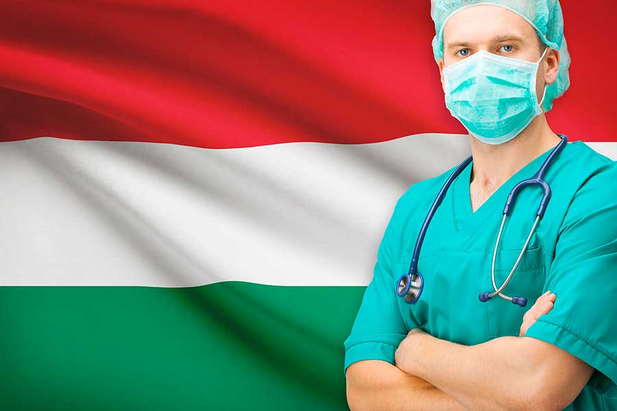 Врач на фоне флага Венгрии, где работа доступна для иностранцев