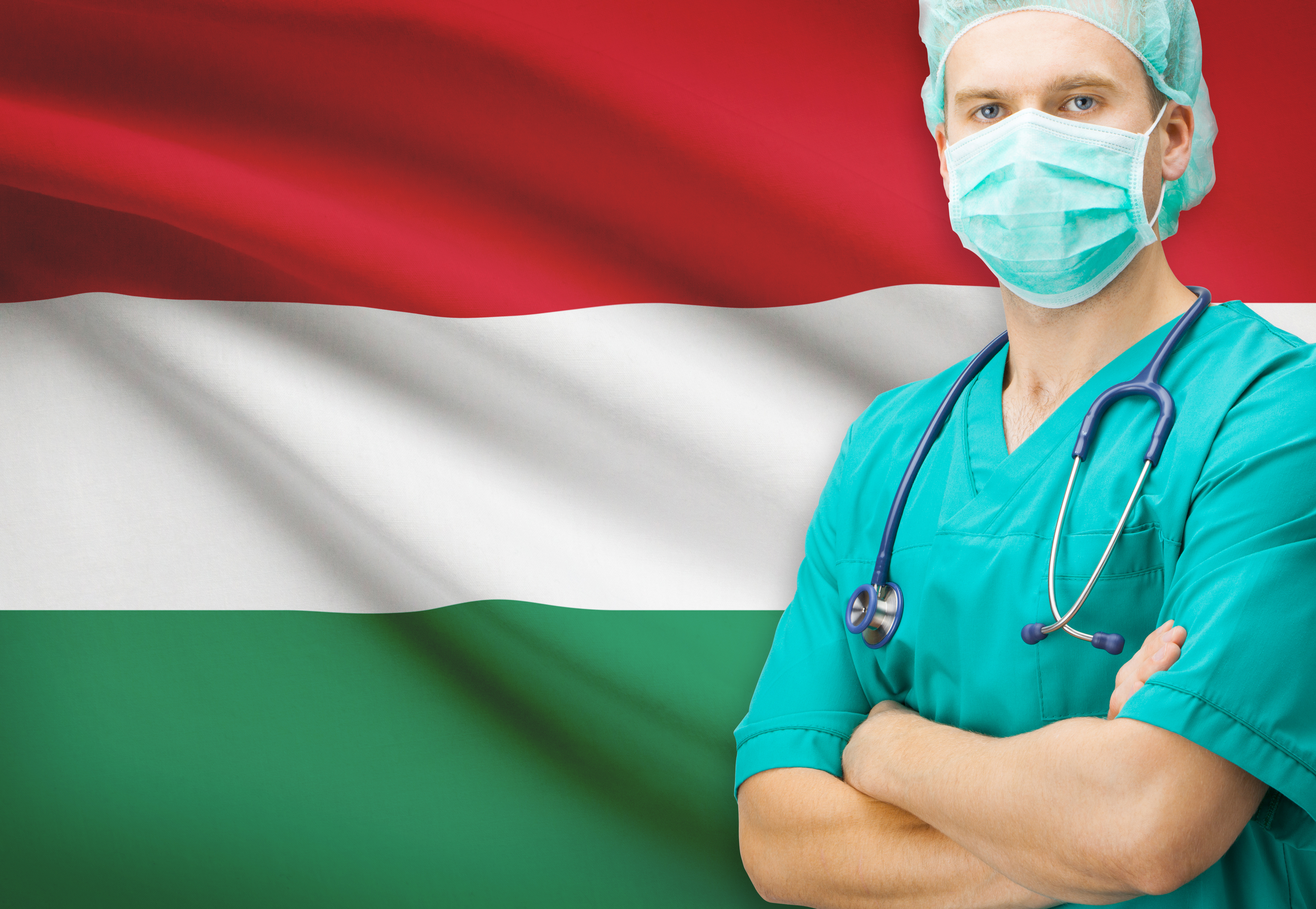 Врач на фоне флага Венгрии, где работа доступна для иностранцев